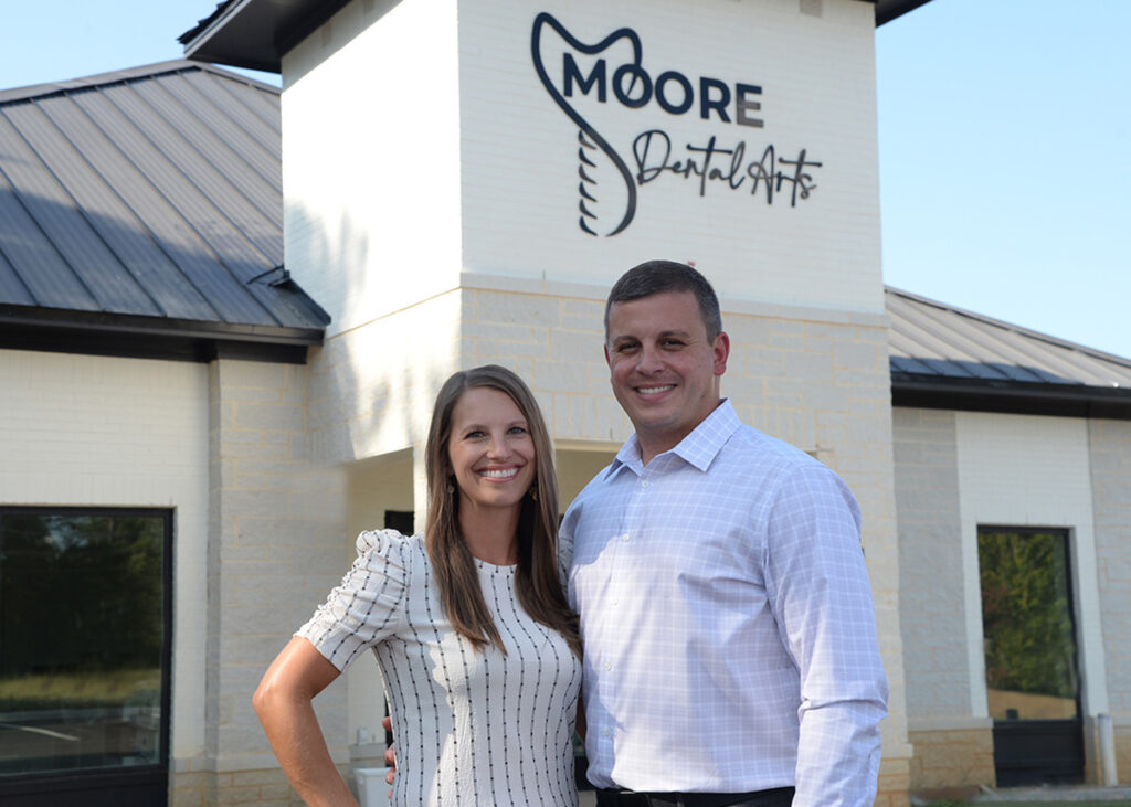 Dr. Chad and Alecia Moore in front of their office