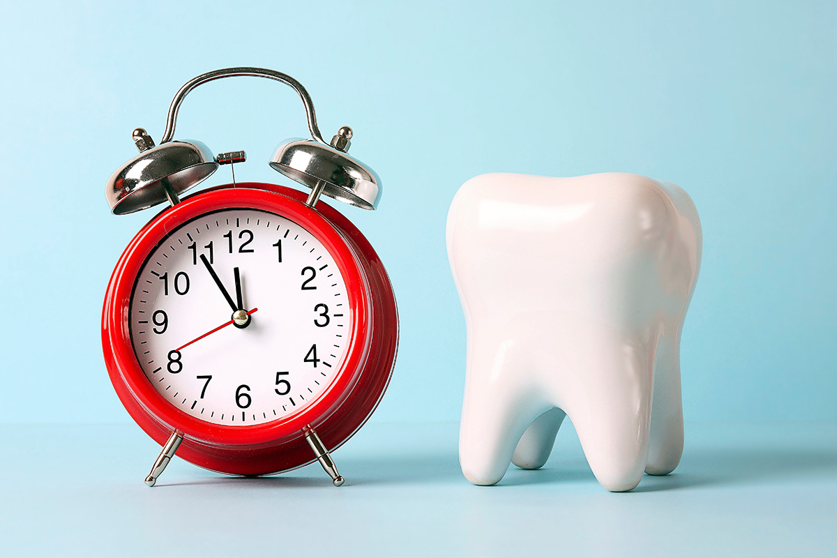 Graphic of clock and tooth illustrating same-day dental implant placement in efficient dentistry.