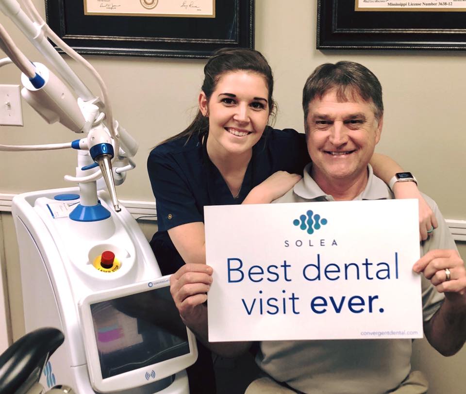 Dental assistant using Solea laser technology for advanced patient dentistry care at Moore Dental Arts.